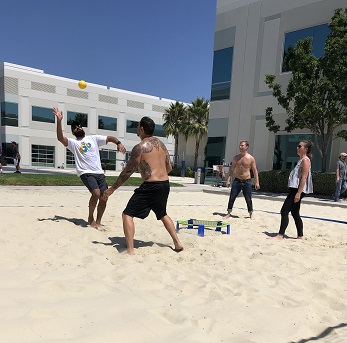 Adrian playing Spikeball with coworkers at lunch