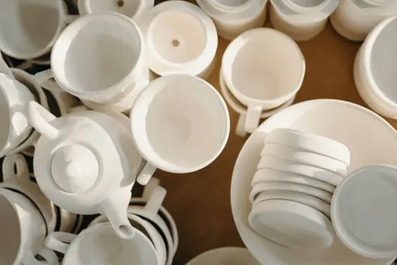 An assortment of white ceramic pottery
