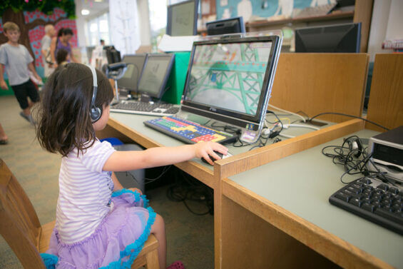A young child plays an educational computer game in her Elementary school in Carlsbad, California