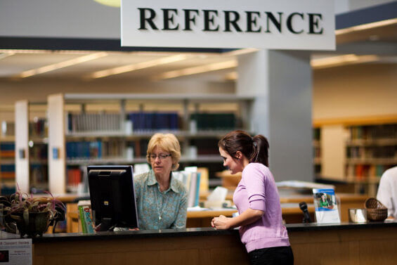 A woman talks with a local librarian